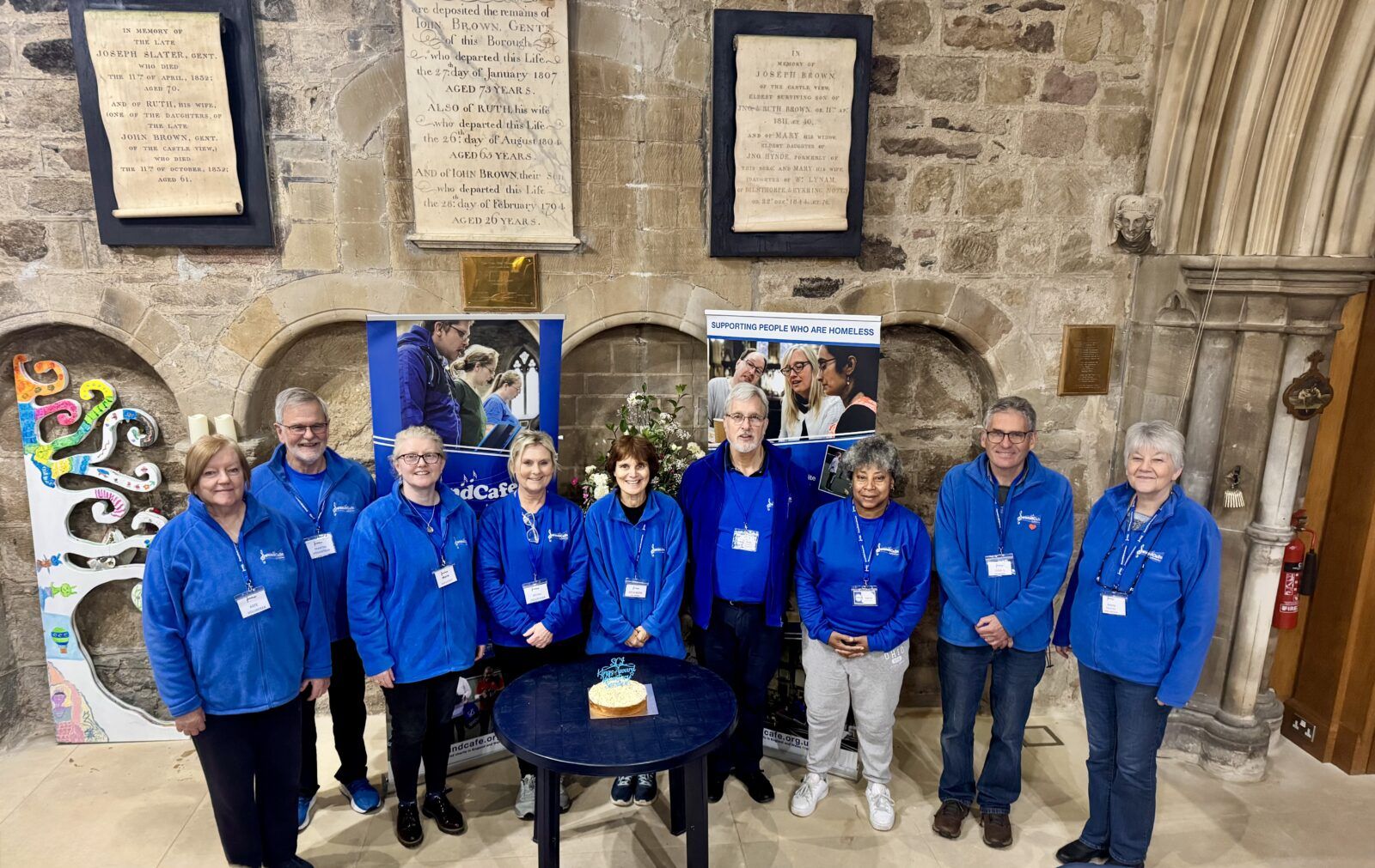 The volunteer team with a celebration cake